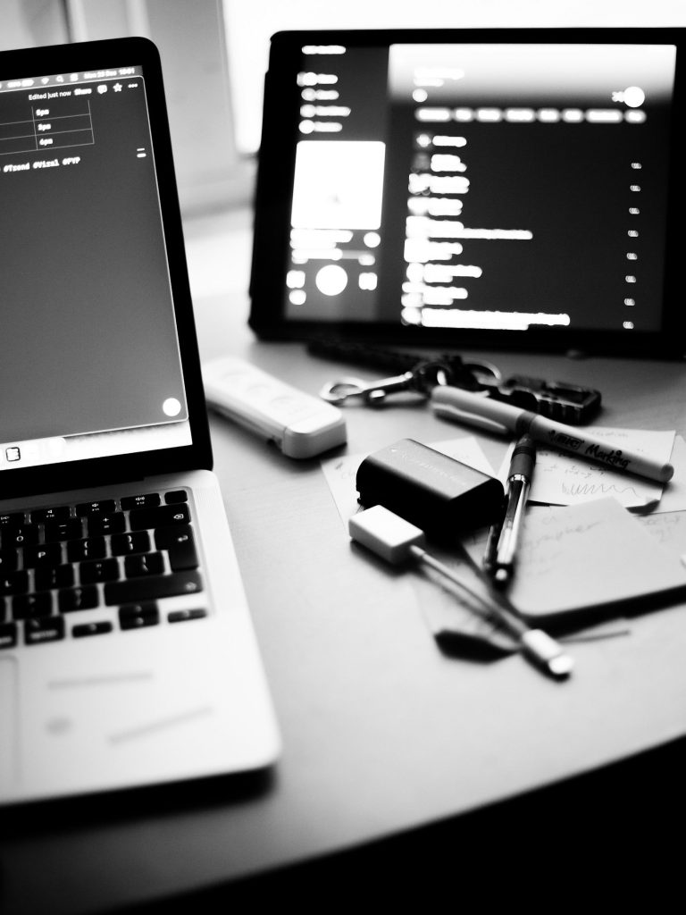 Laptop and tablet displaying strategy dashboards and data